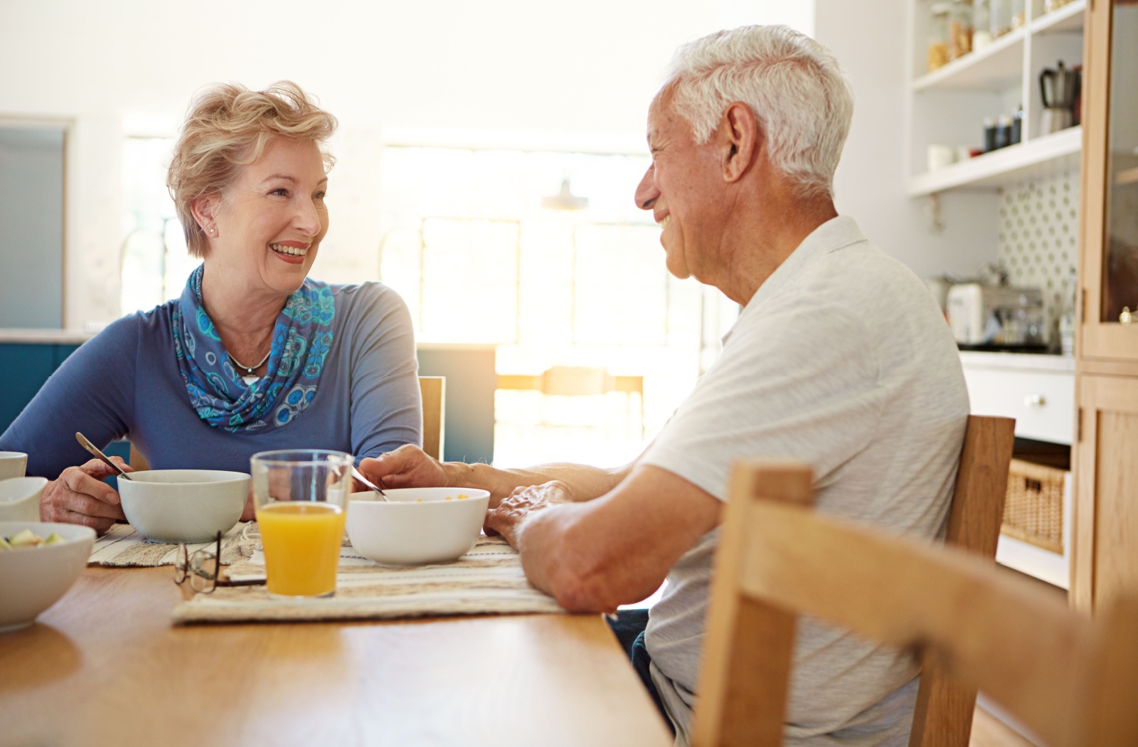 A senior couple enjoys breakfast in their independent living apartment